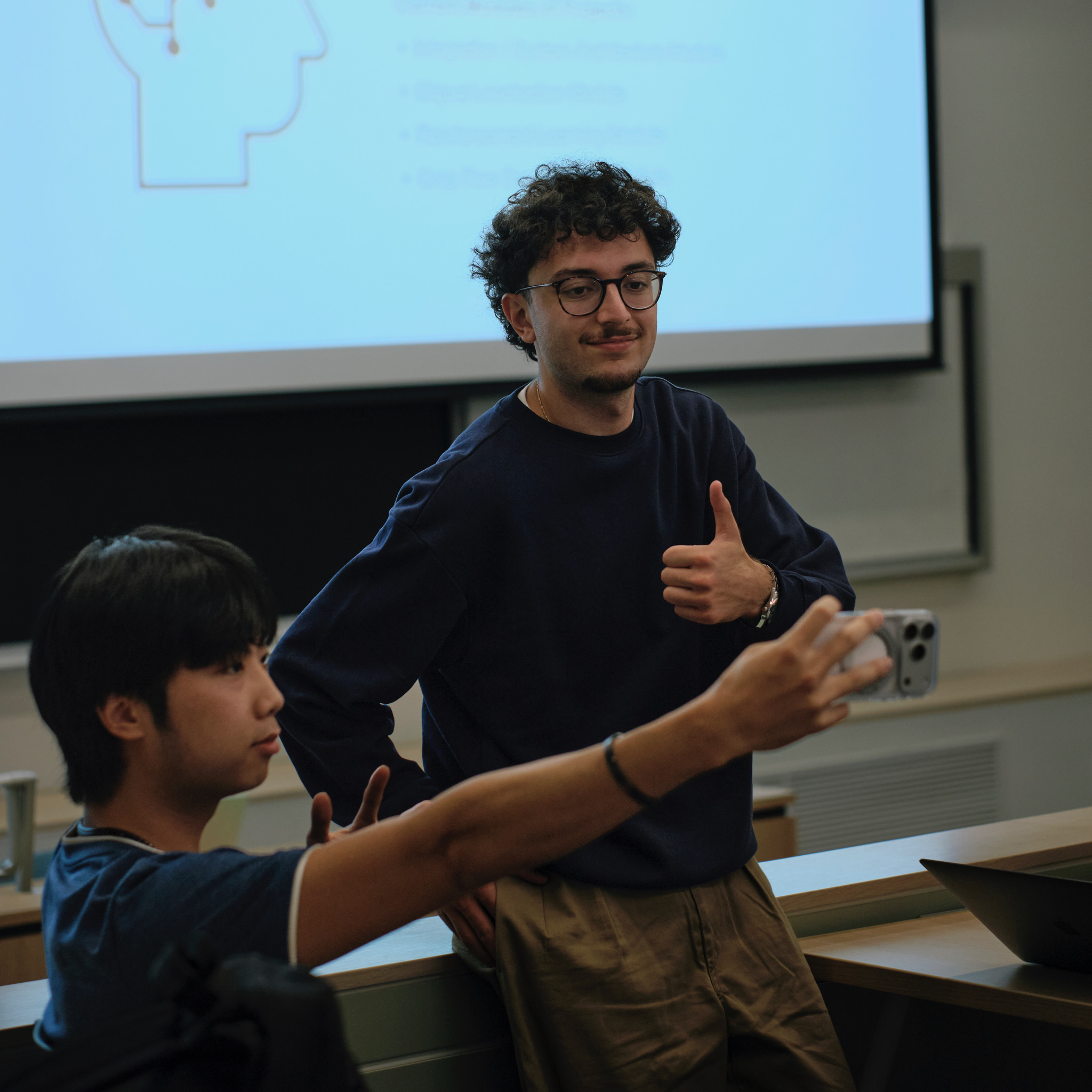 Team members presenting project research in a lecture hall
