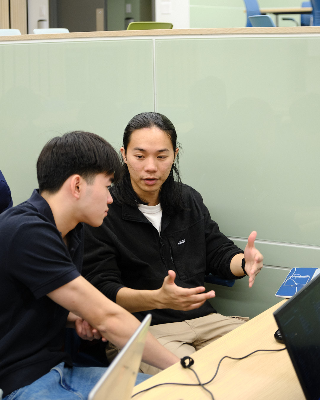 Team members reviewing code together at a laptop